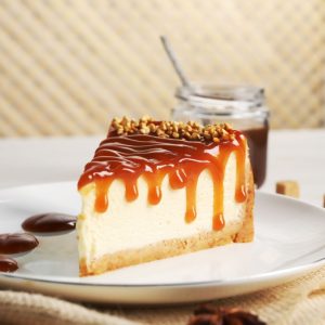 Tasty,Cheesecake,With,Caramel,And,Nuts,Served,On,Table